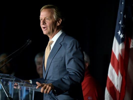 HASLAM SIGNS HALL TAX REPEAL.